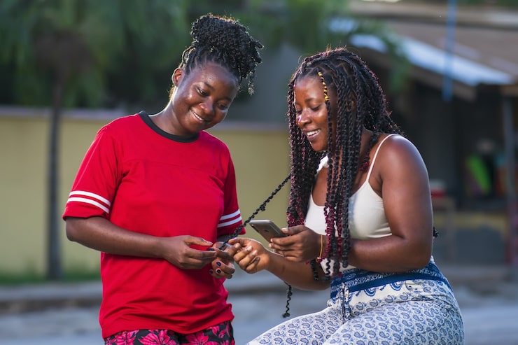 Two BidBoxx members celebrating a loan unlocked through the app